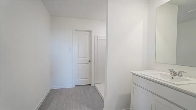 a bathroom with a granite countertop sink