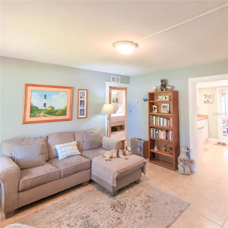 120 Rhode Island Street Edgewater, FL 32132 - Photo 12 of 28 a living room with furniture and a book shelf