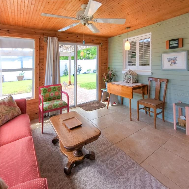 120 Rhode Island Street Edgewater, FL 32132 - Photo 16 of 28 a living room with furniture and floor to ceiling windows