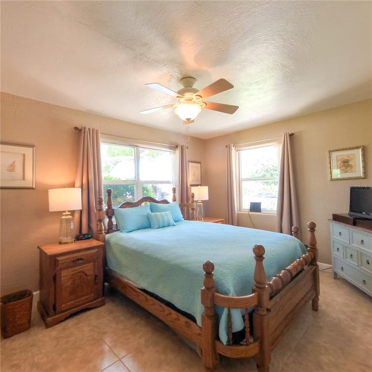 120 Rhode Island Street Edgewater, FL 32132 - Photo 17 of 28 a bedroom with a bed and a chandelier