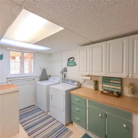 a kitchen with a sink cabinets and window