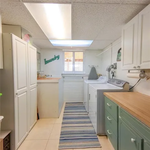 a kitchen with a refrigerator sink and cabinets