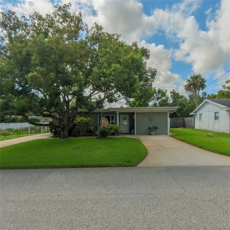 120 Rhode Island Street Edgewater, FL 32132 - Photo 2 of 28 a front view of a house with a yard and garage