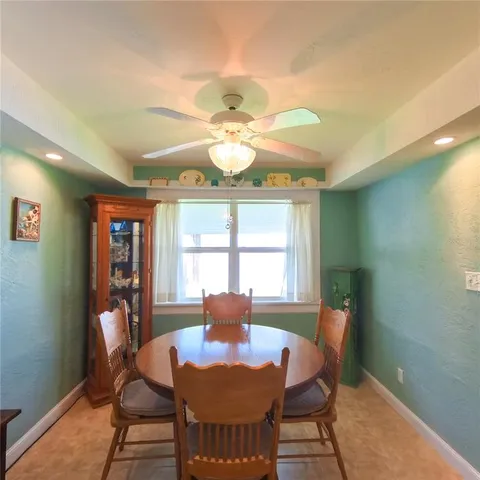 a dining room with furniture and window