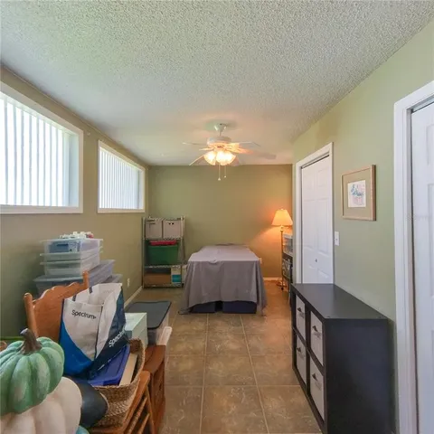 a bedroom with furniture and a chandelier