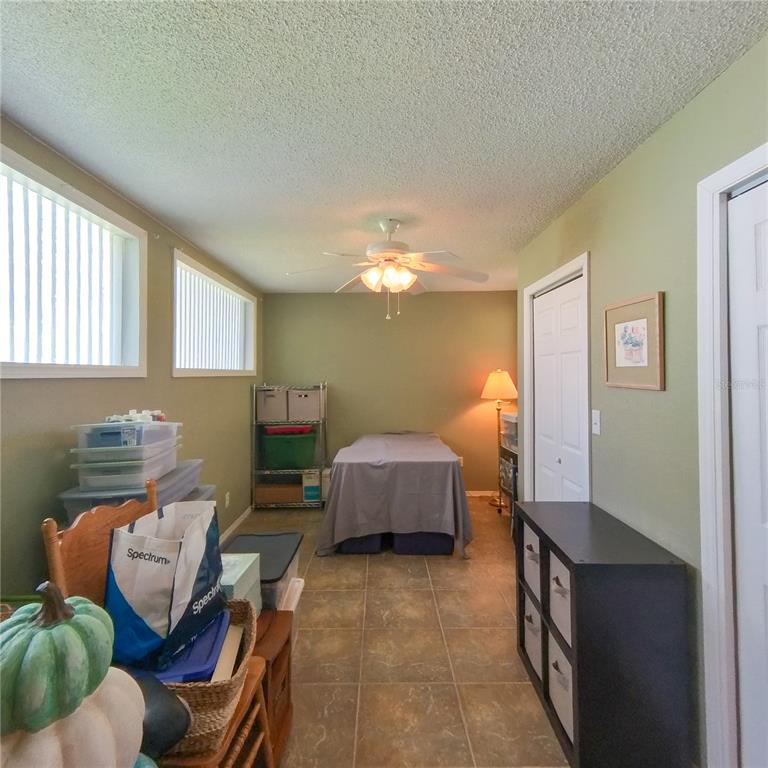 120 Rhode Island Street Edgewater, FL 32132 - Photo 23 of 28 a bedroom with furniture and a chandelier