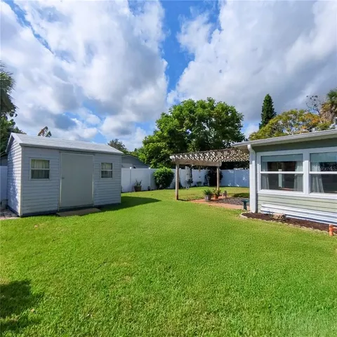 a view of a house with a swimming pool and a yard
