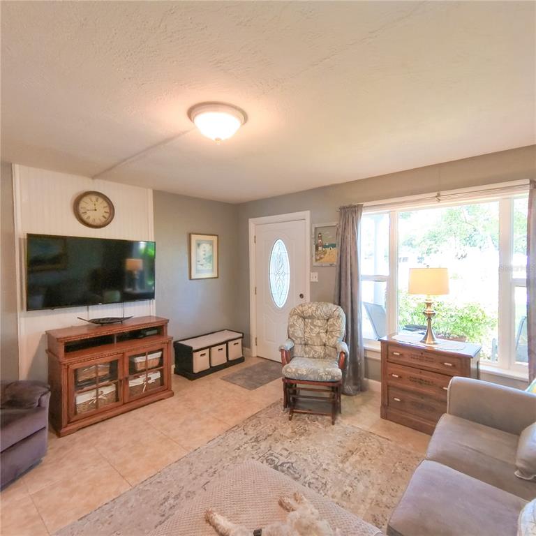 120 Rhode Island Street Edgewater, FL 32132 - Photo 10 of 28 a living room with furniture and a flat screen tv