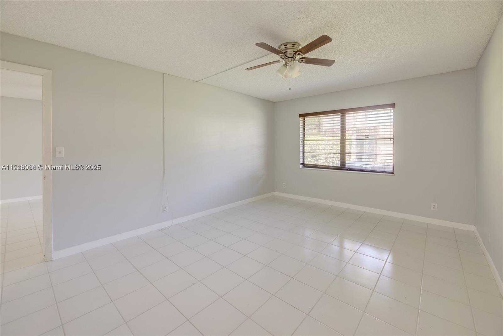 31 Cortez Way, Unit 543 Davie, FL 33324 - Photo 18 of 36 an empty room with windows and fan