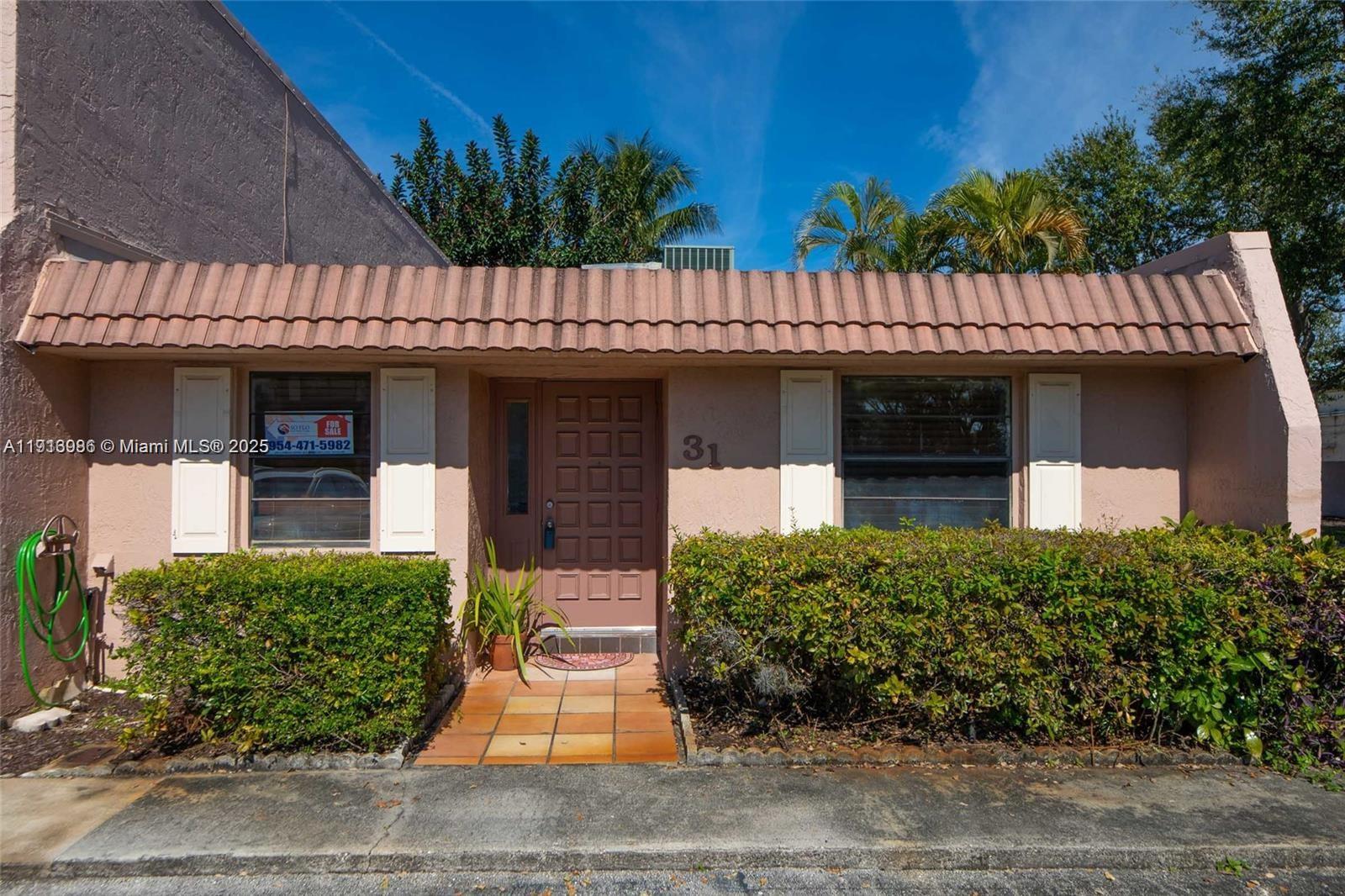 31 Cortez Way, Unit 543 Davie, FL 33324 - Photo 2 of 36 a front view of a house with a garden