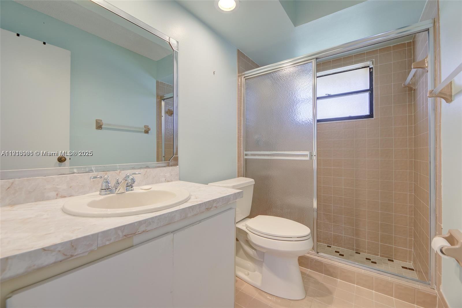 31 Cortez Way, Unit 543 Davie, FL 33324 - Photo 25 of 36 a bathroom with a sink a toilet and shower
