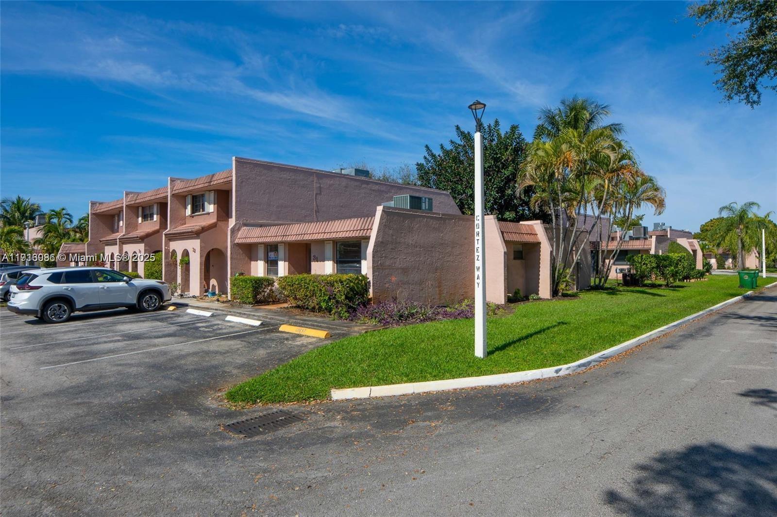 31 Cortez Way, Unit 543 Davie, FL 33324 - Photo 28 of 36 a front view of a house with a yard and garage