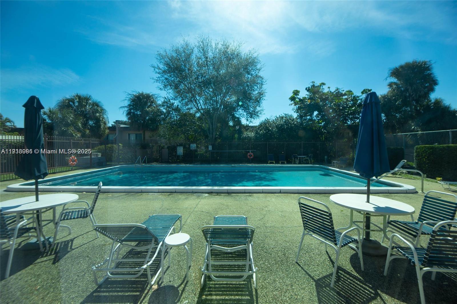 31 Cortez Way, Unit 543 Davie, FL 33324 - Photo 32 of 36 a view of swimming pool with chairs