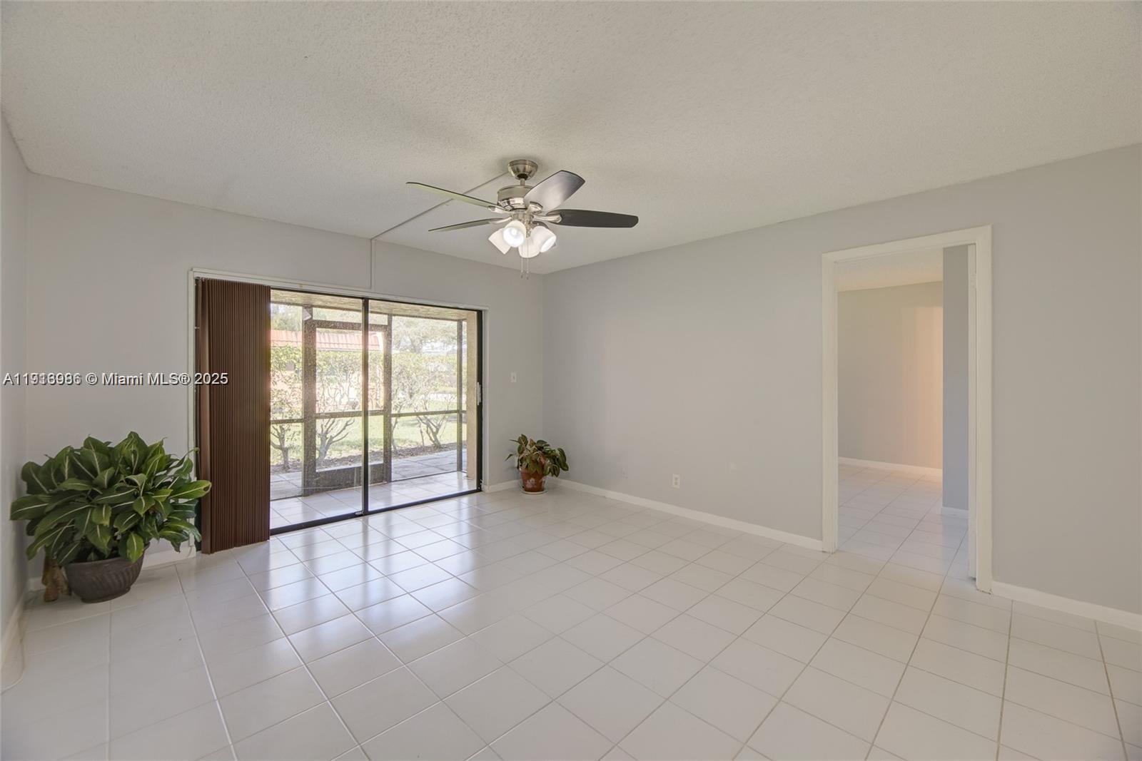31 Cortez Way, Unit 543 Davie, FL 33324 - Photo 4 of 36 an empty room with windows and ceiling fan