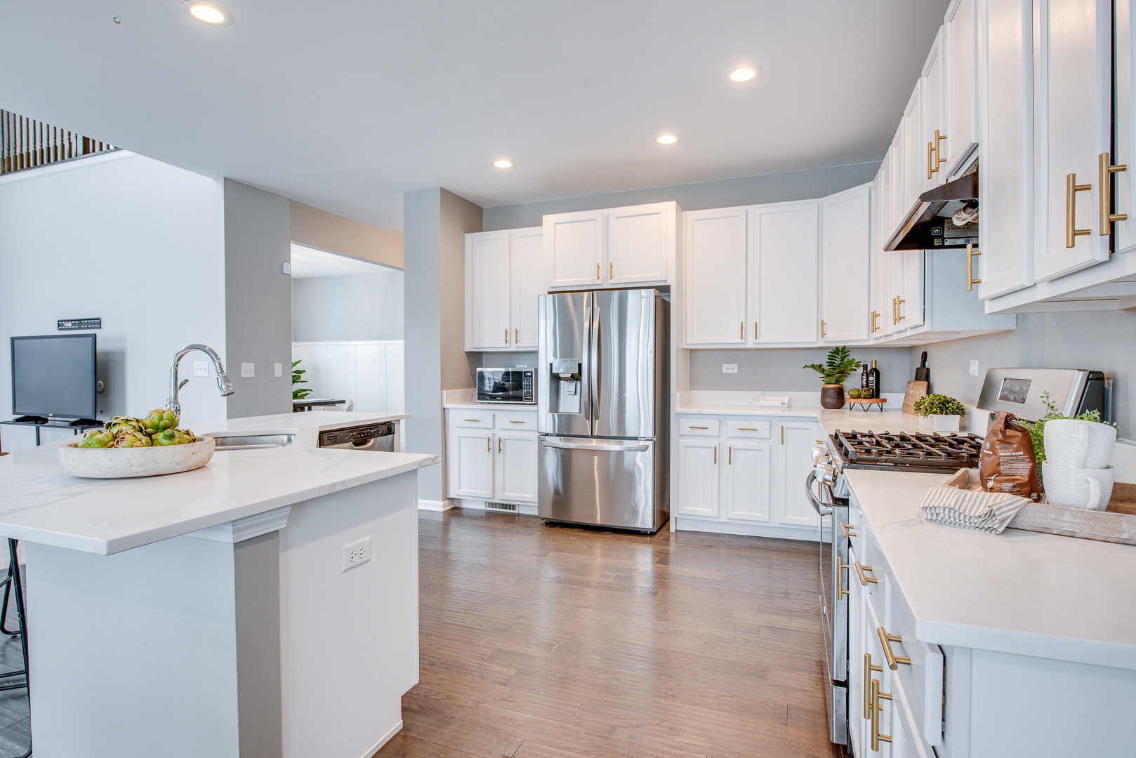 12811 Conifer Street Plainfield, IL 60585 - Photo 11 of 47 a kitchen with a sink a stove a refrigerator and white cabinets