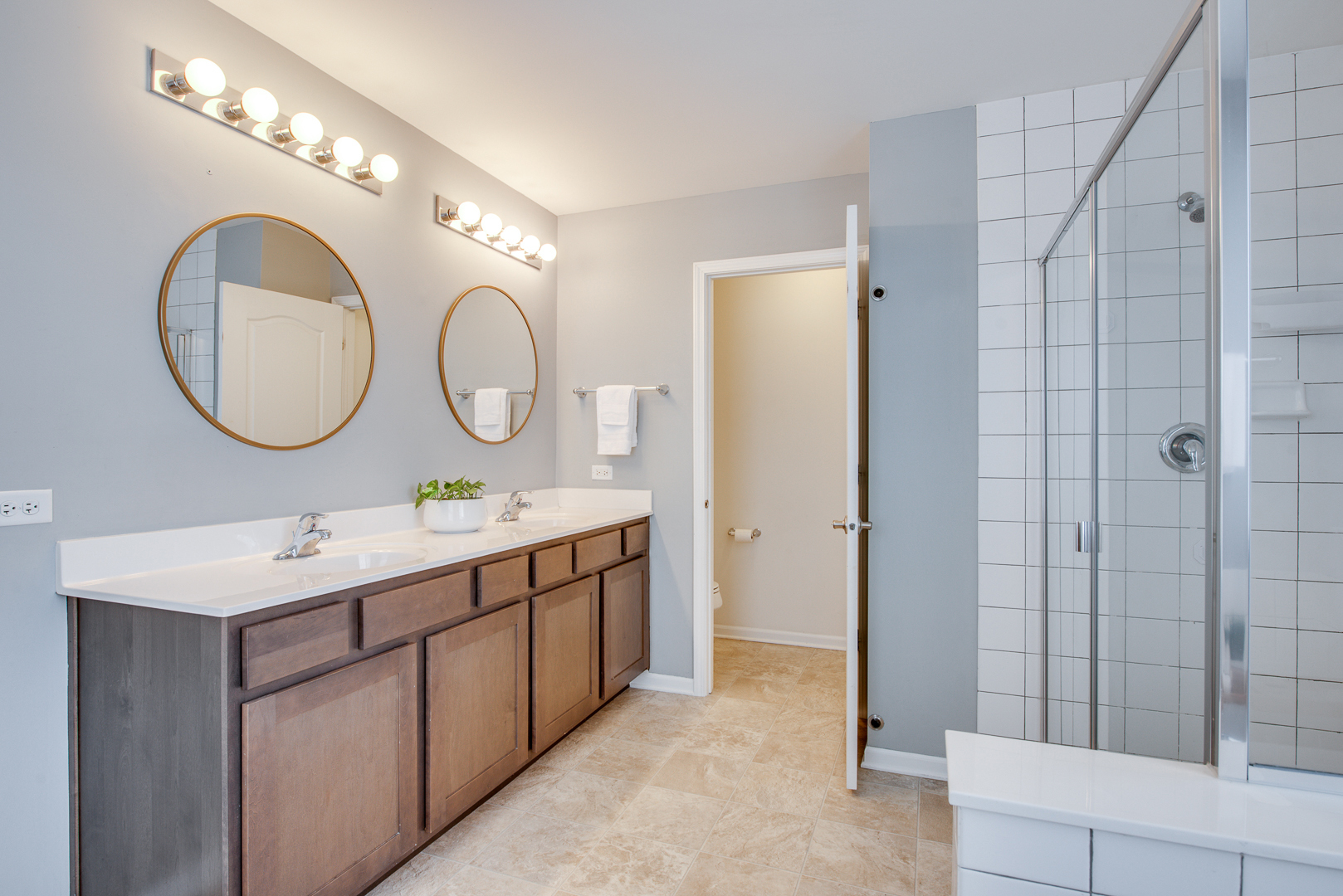 12811 Conifer Street Plainfield, IL 60585 - Photo 24 of 47 a bathroom with a double vanity sink and a mirror