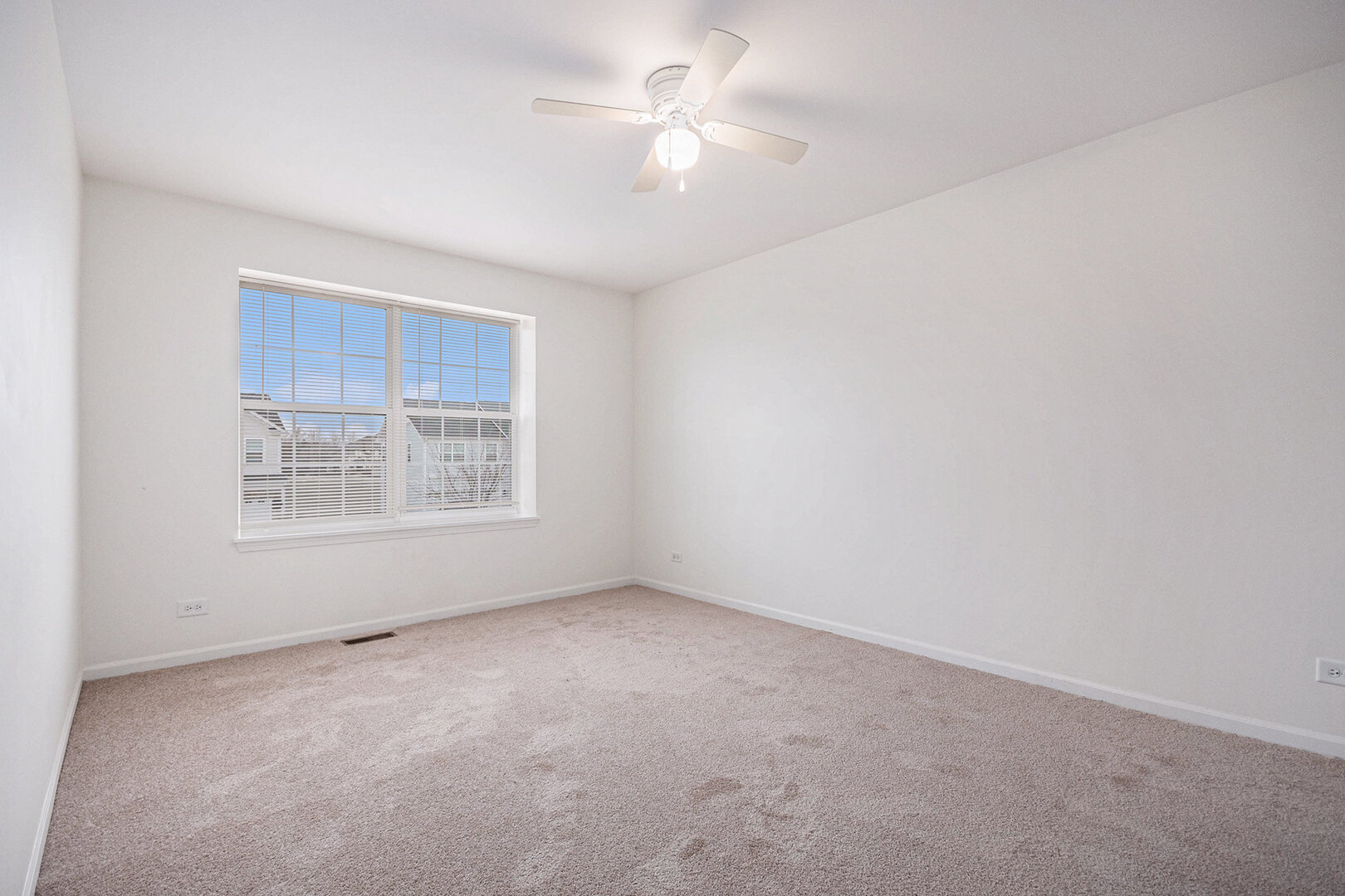 12811 Conifer Street Plainfield, IL 60585 - Photo 26 of 47 an empty room with a fan & a window