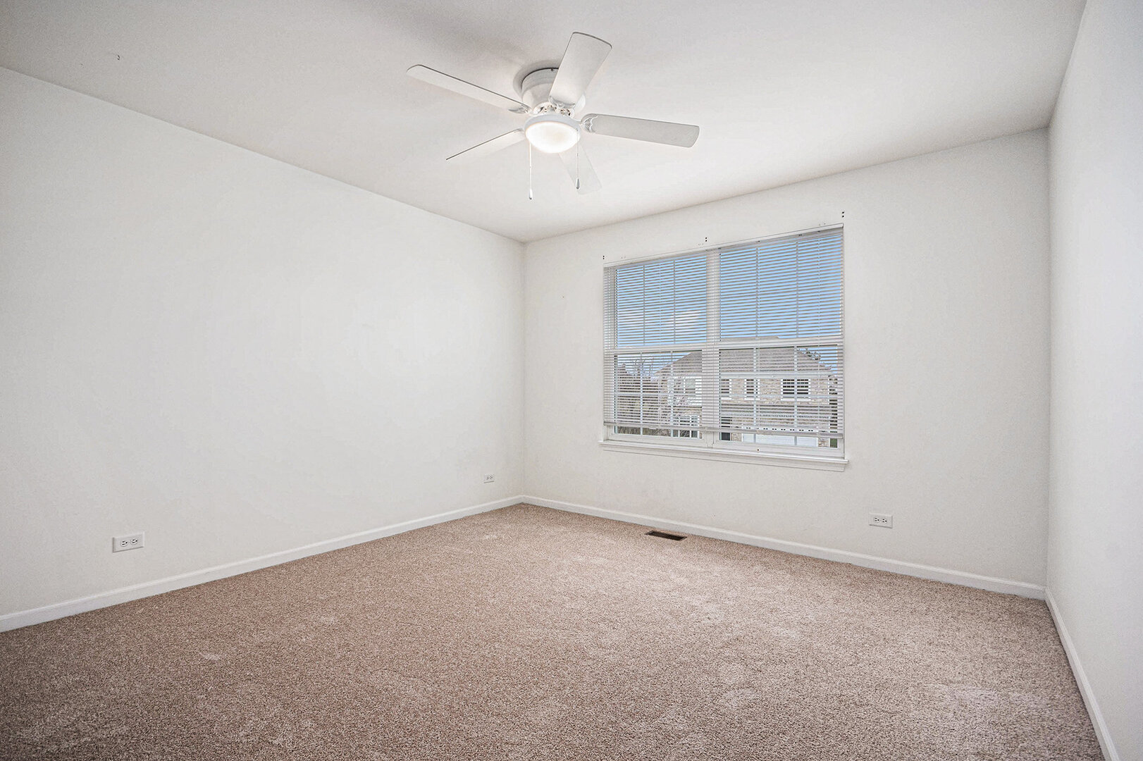 12811 Conifer Street Plainfield, IL 60585 - Photo 27 of 47 an empty room with a chandelier fan and windows