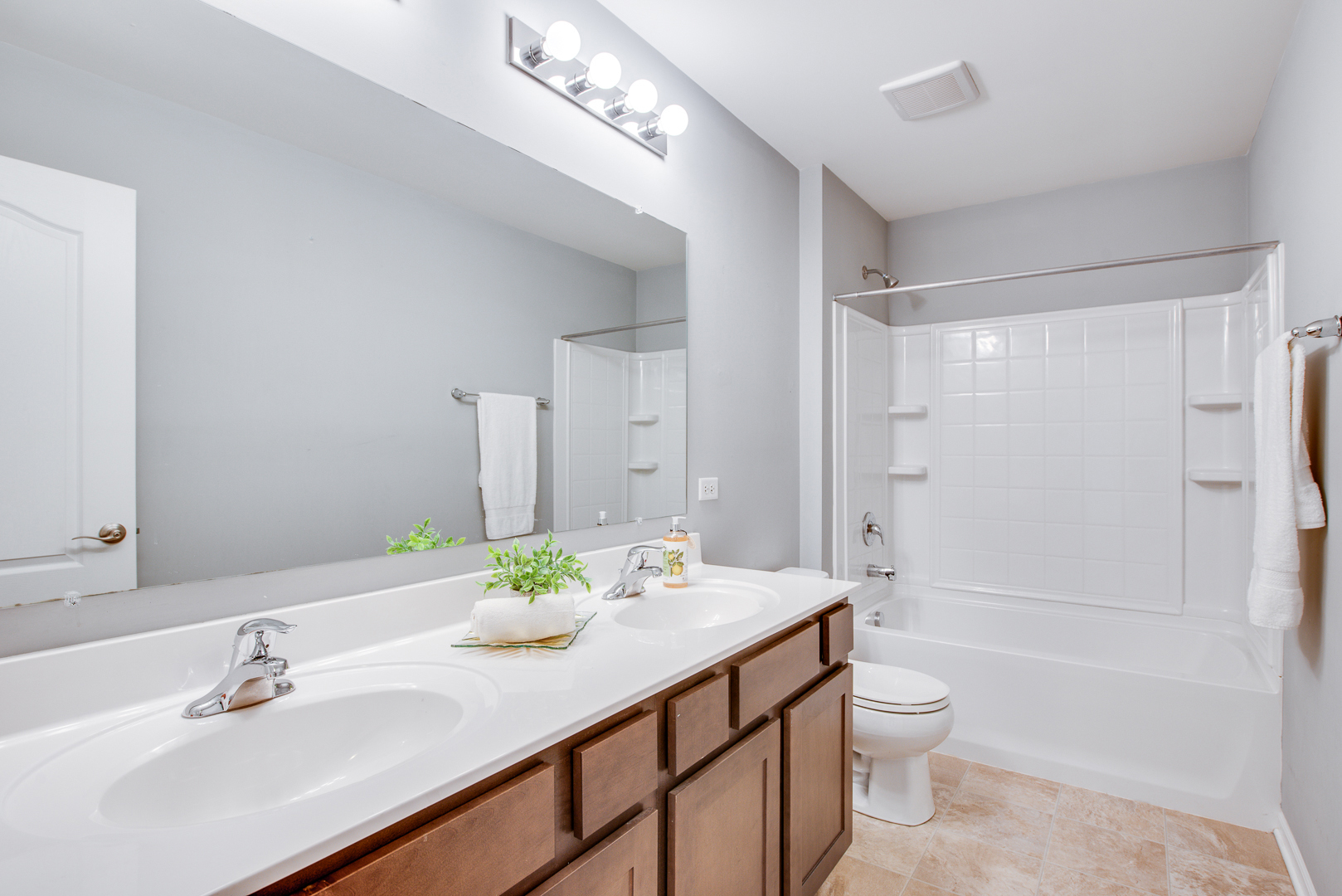 12811 Conifer Street Plainfield, IL 60585 - Photo 28 of 47 a bathroom with a sink a toilet and shower