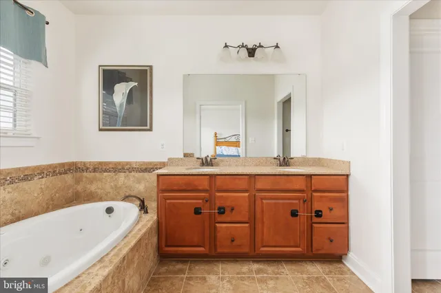 a bathroom with a granite countertop sink toilet and a mirror