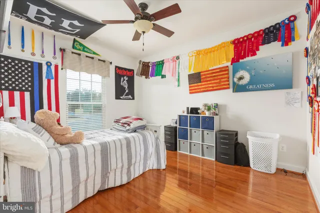 a bathroom with a granite countertop toilet sink and mirror