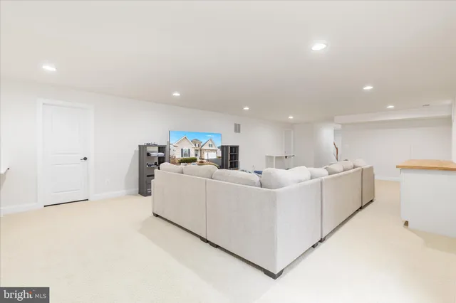 a view of a house with wooden deck and furniture