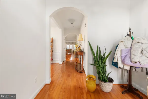 a kitchen with stainless steel appliances a sink a microwave a refrigerator and wooden cabinets