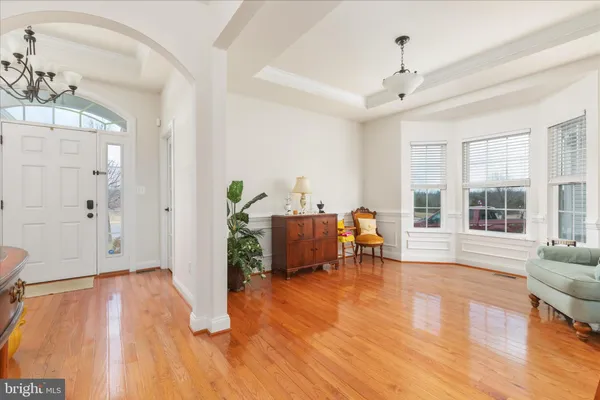 a dining room with furniture window and wooden floor