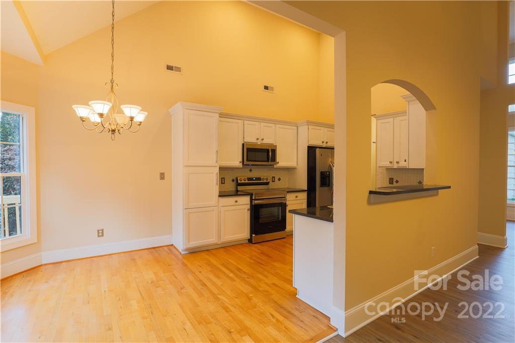 142 Princess Loop Troutman, NC 28166 - Photo 11 of 22 a kitchen with stainless steel appliances granite countertop a refrigerator a stove and a sink