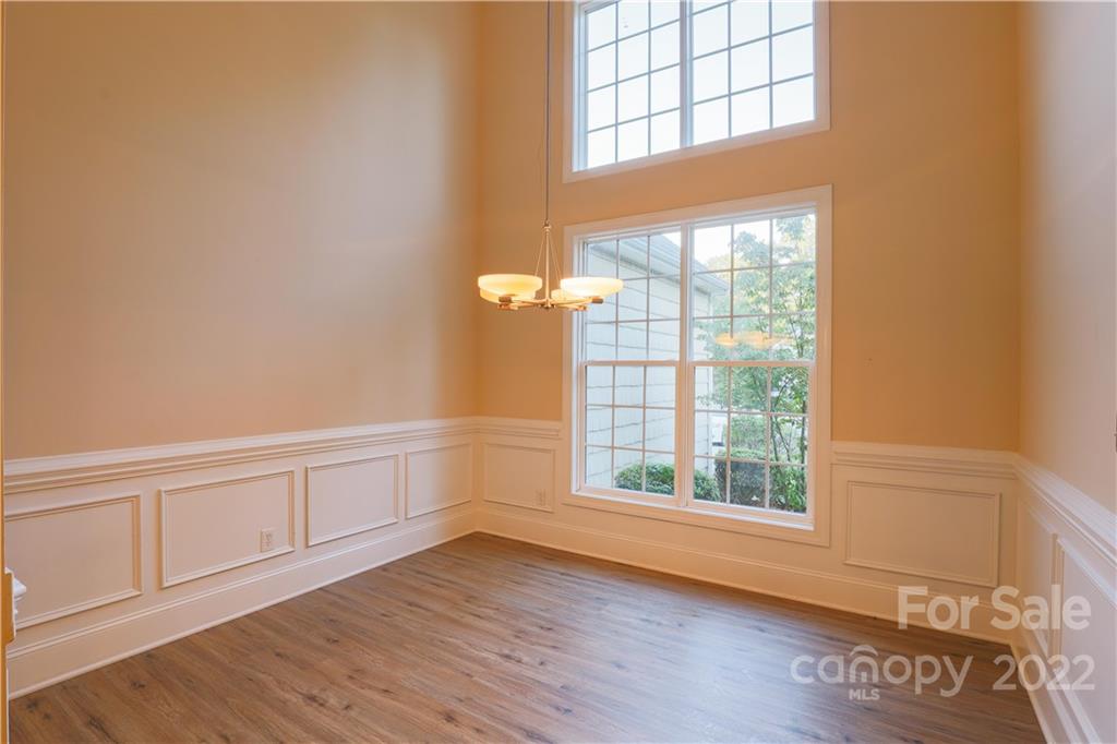 142 Princess Loop Troutman, NC 28166 - Photo 13 of 22 an empty room with wooden floor and windows