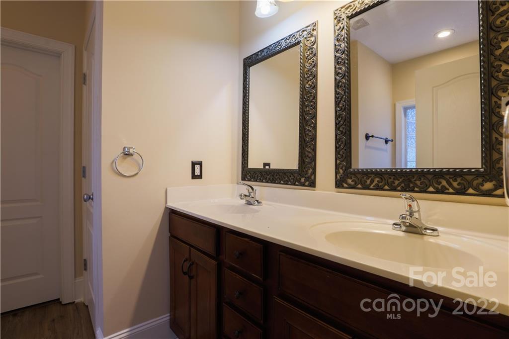 142 Princess Loop Troutman, NC 28166 - Photo 15 of 22 a bathroom with a double vanity sink and a mirror