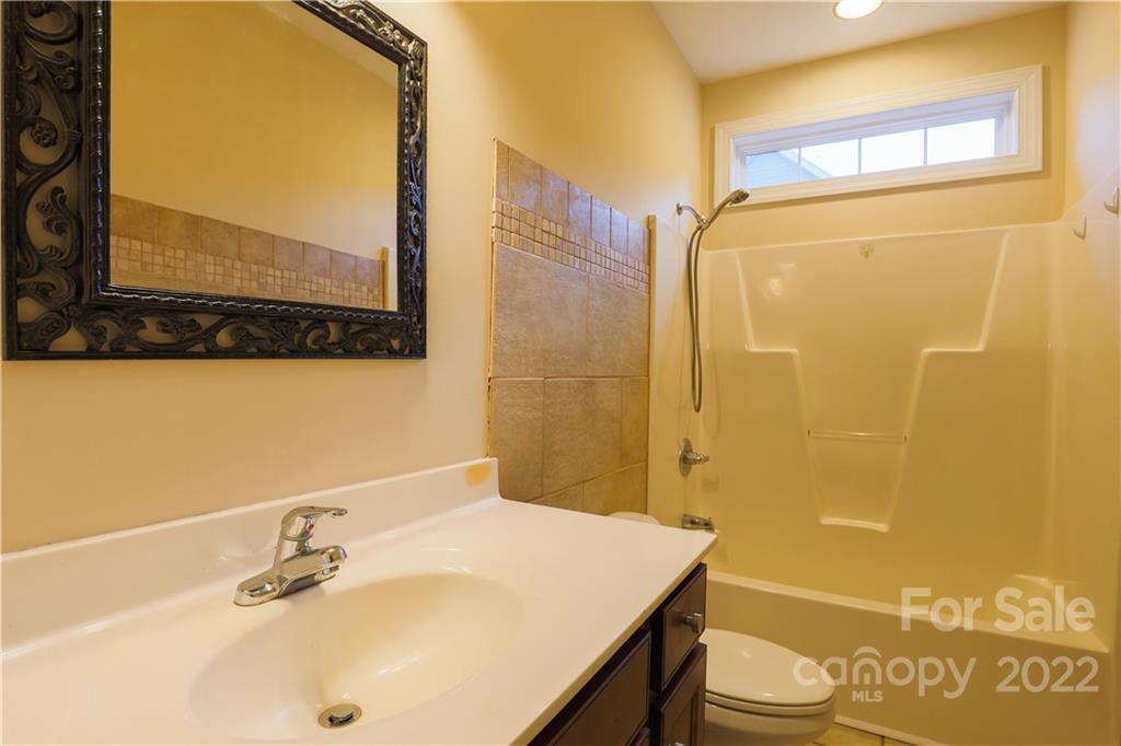 142 Princess Loop Troutman, NC 28166 - Photo 17 of 22 a bathroom with a sink a toilet and shower