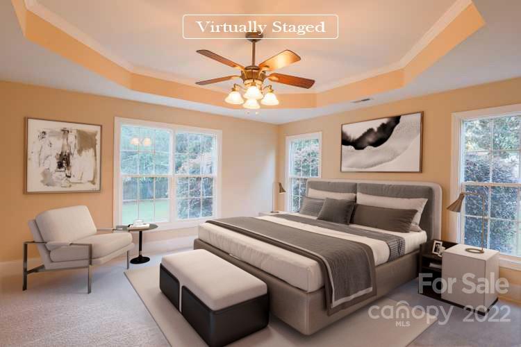 142 Princess Loop Troutman, NC 28166 - Photo 4 of 22 a bedroom with a bed and a chandelier