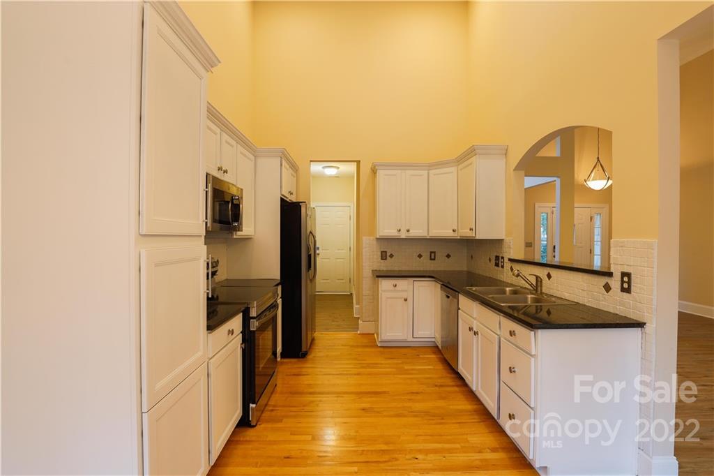 142 Princess Loop Troutman, NC 28166 - Photo 6 of 22 a kitchen with stainless steel appliances granite countertop a sink and cabinets