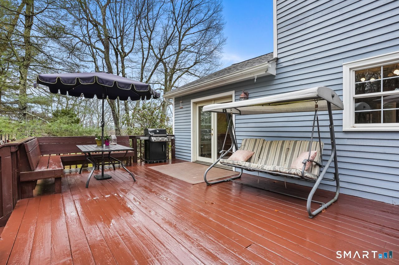 46 Little Brook Lane Newtown, CT 06470 - Photo 12 of 27 a view of patio with a table and chairs under an umbrella with wooden floor