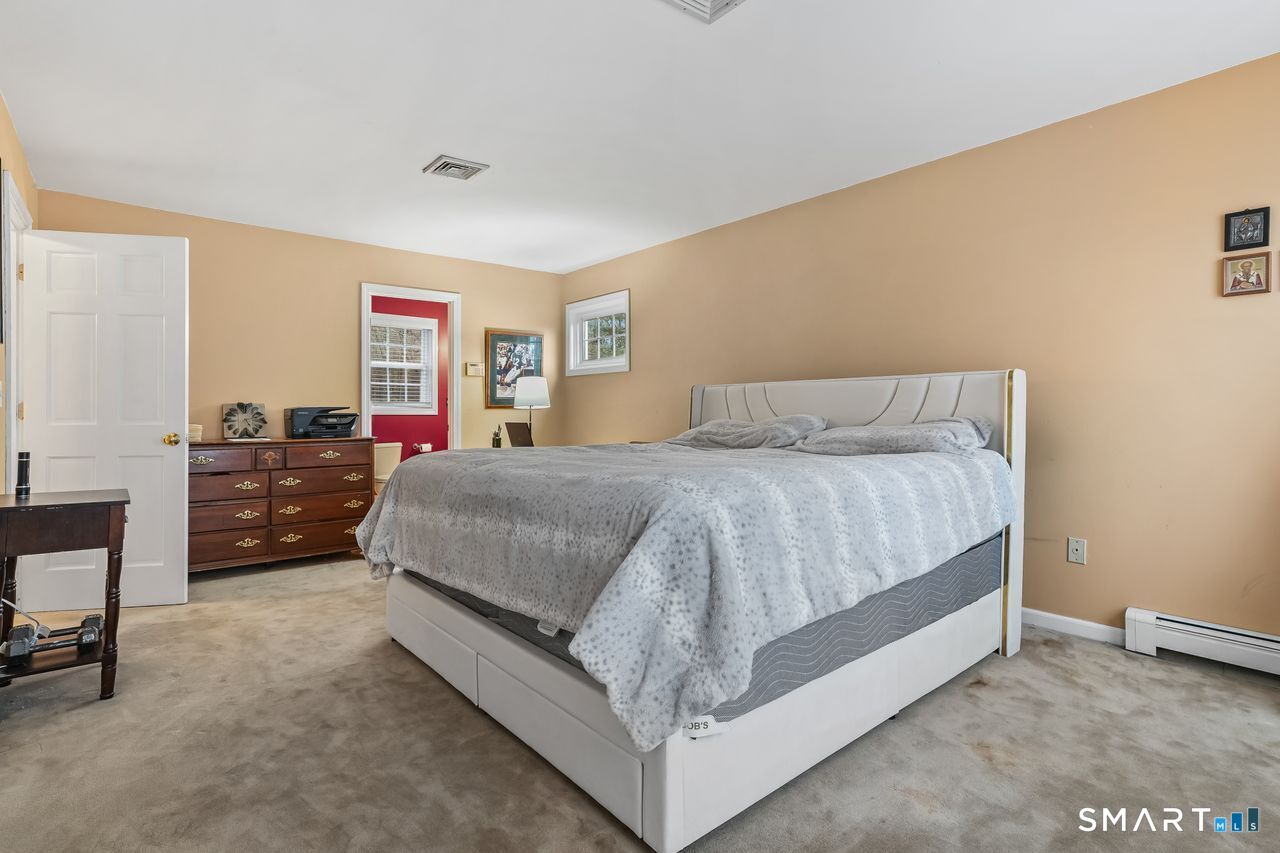 46 Little Brook Lane Newtown, CT 06470 - Photo 14 of 27 a bedroom with a bed and a couch