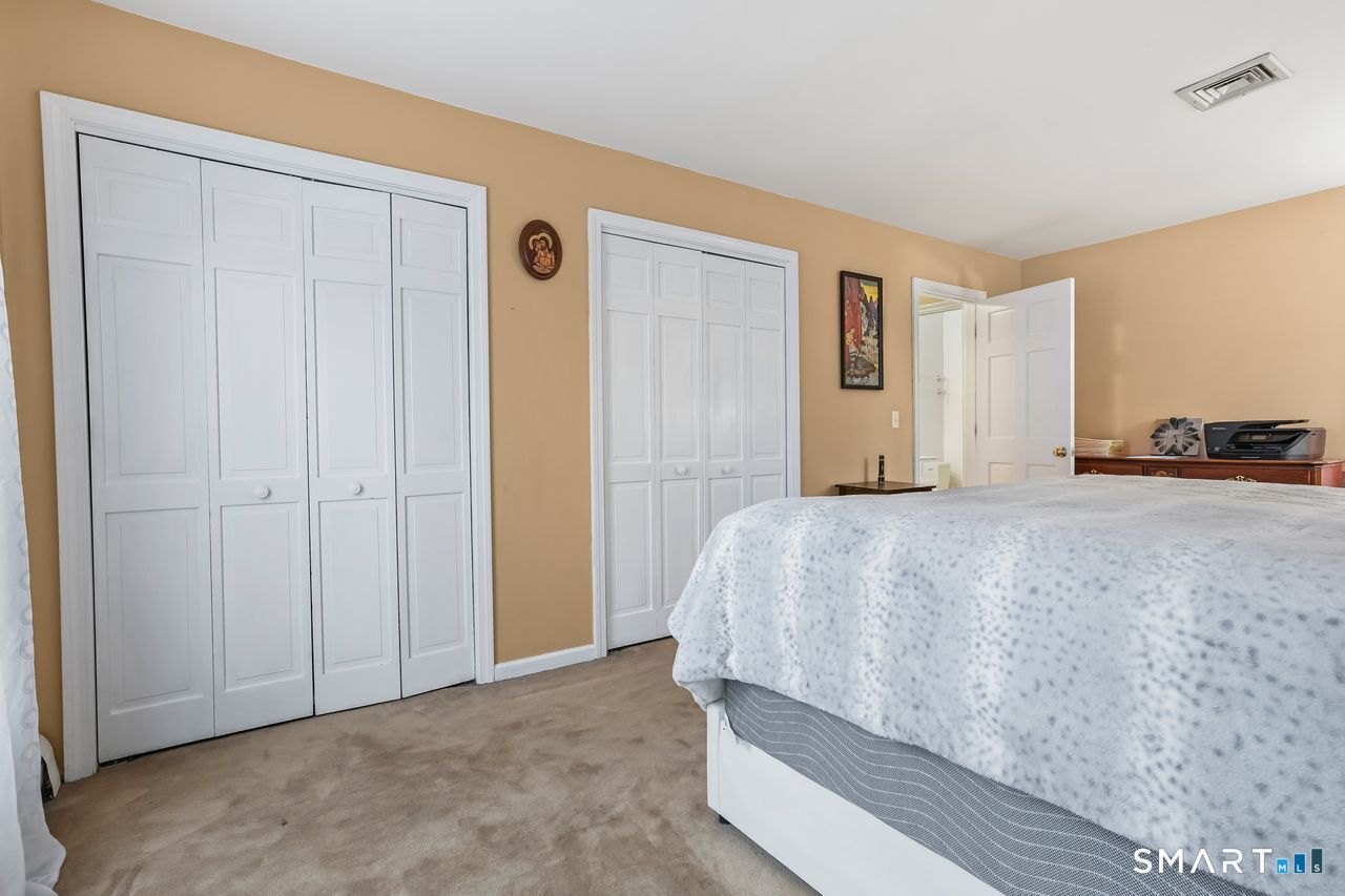 46 Little Brook Lane Newtown, CT 06470 - Photo 16 of 27 a bedroom with a bed and a mirror