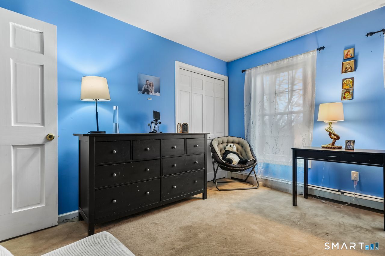 46 Little Brook Lane Newtown, CT 06470 - Photo 19 of 27 a room with a bed and a lamp on dresser