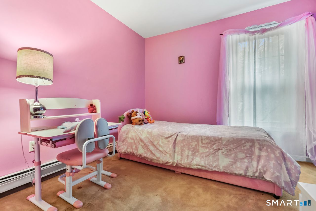 46 Little Brook Lane Newtown, CT 06470 - Photo 20 of 27 a bedroom with a bed and a lamp