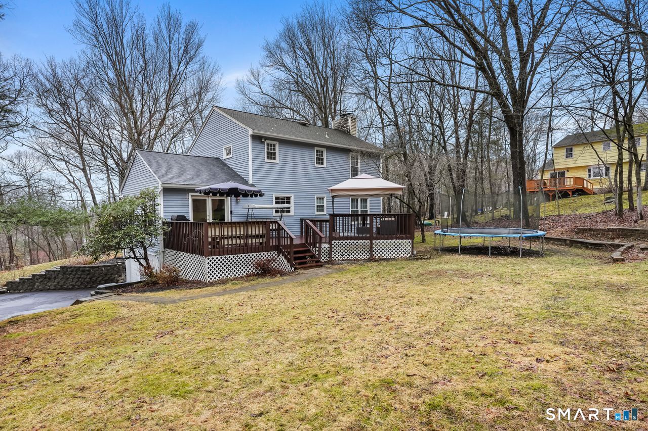 46 Little Brook Lane Newtown, CT 06470 - Photo 2 of 27 a view of a house with large trees and sitting area