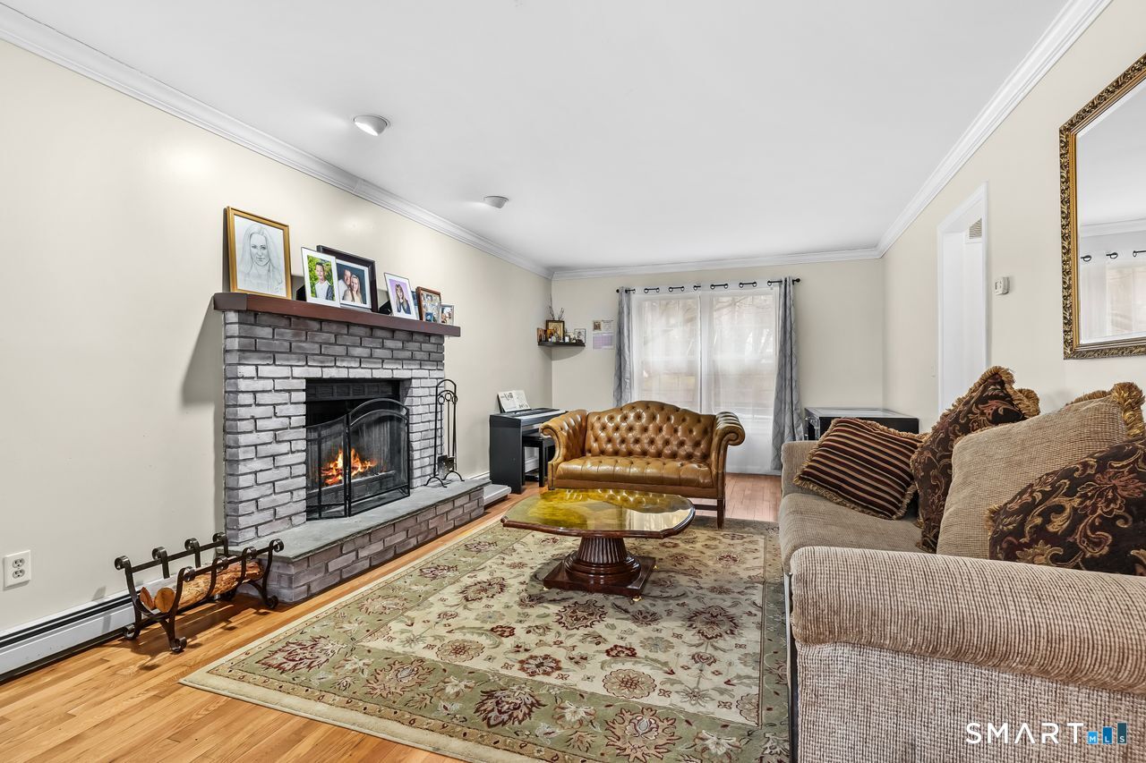 46 Little Brook Lane Newtown, CT 06470 - Photo 3 of 27 a living room with furniture and a fireplace
