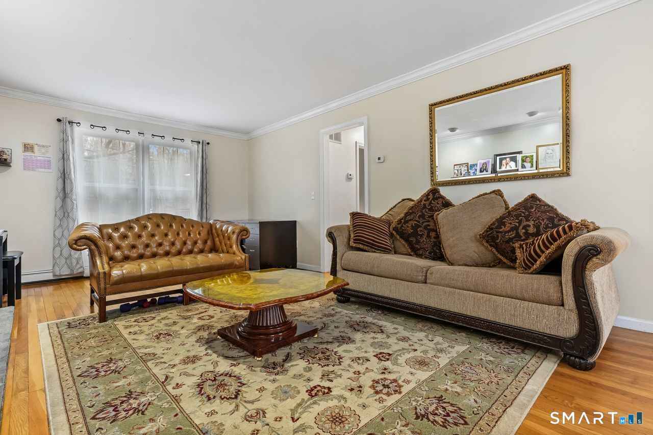 46 Little Brook Lane Newtown, CT 06470 - Photo 5 of 27 a living room with a couch and a coffee table