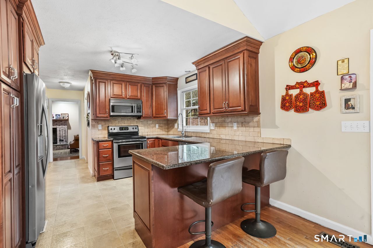 46 Little Brook Lane Newtown, CT 06470 - Photo 7 of 27 a kitchen with a refrigerator and a stove top oven