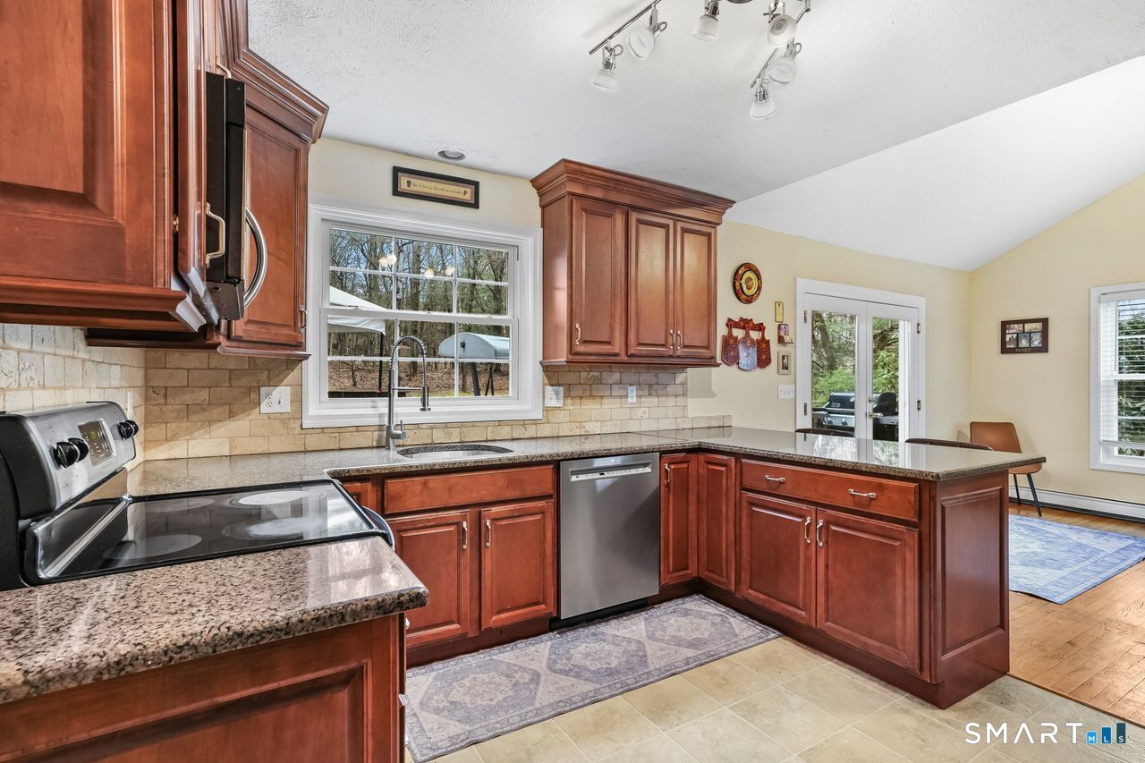 46 Little Brook Lane Newtown, CT 06470 - Photo 9 of 27 a kitchen with a sink stove and cabinets