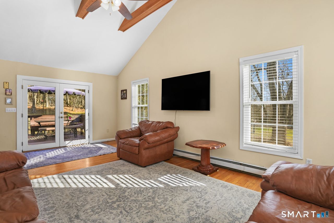 46 Little Brook Lane Newtown, CT 06470 - Photo 10 of 27 a living room with furniture and a flat screen tv