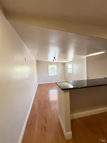 a kitchen with granite countertop a sink and a stove