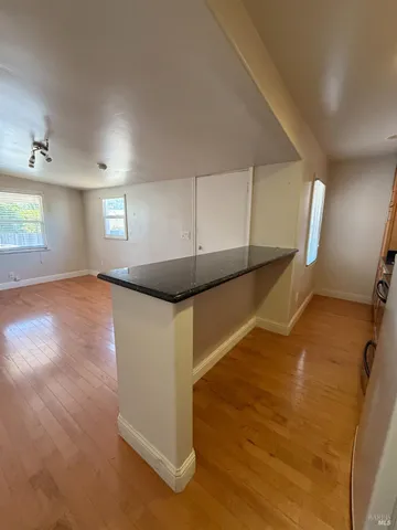 a view of an empty room with windows and stairs