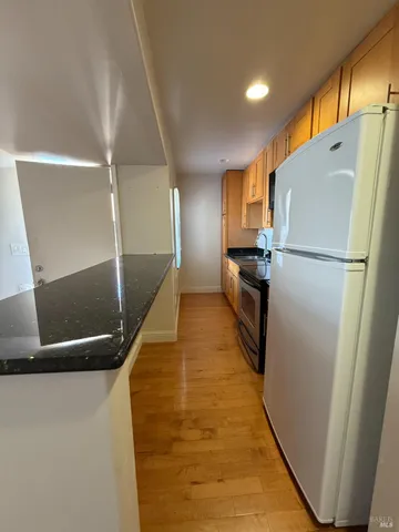 a view of a kitchen with a refrigerator