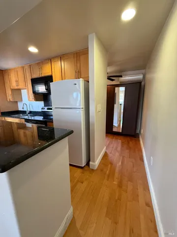 a kitchen with stainless steel appliances a refrigerator and a microwave
