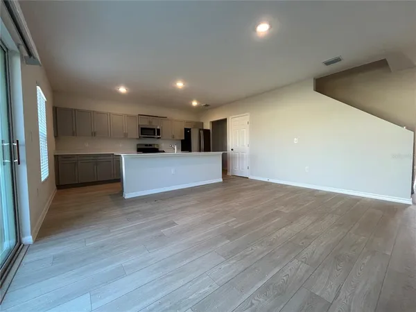 a view of a kitchen with a sink and a refrigerator
